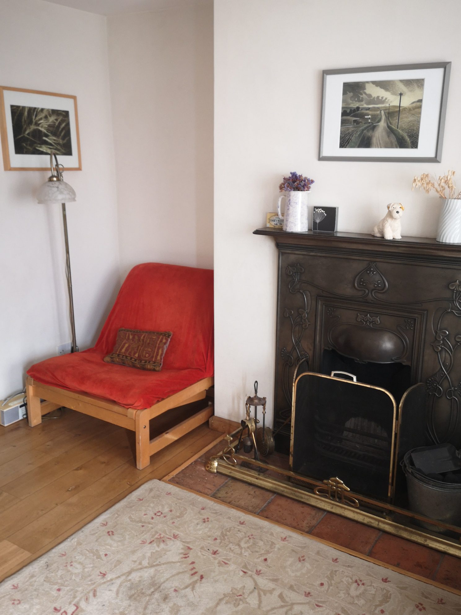 Cosy living room with open fire at Priory Cottage